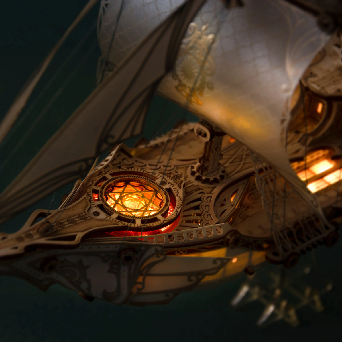 Close-up of warm LED lighting and intricate decorative details on the Fantasy Elfship wooden model